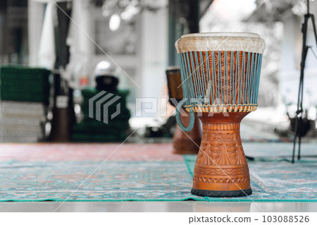 Djembe Drum Djembe Drum is a traditional African musical instrument, standing on a summer terrace in Indonesia 103088526