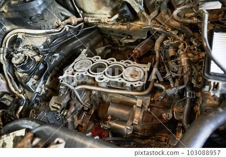 Close up of car being serviced in auto station, center. Repairmen, mechanics, workers servicing, maintaining car, fixing, repairing problem. Concept of repairing automobiles. Close up of car being serviced in auto station, center. Repairmen, mechanics, workers servicing, maintaining car, fixing, repairing problem. Concept of repairing automobiles. 103088957