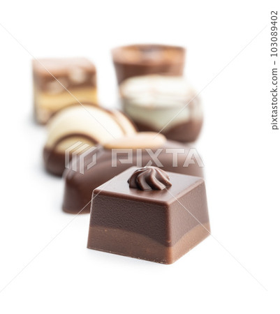 Sweet chocolate pralines.  Tasty chocolate truffles isolated on white background. 103089402