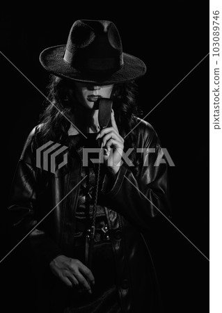 dominant woman with a leather whip flogger for BDSM sex with submission and domination in the hands 103089746