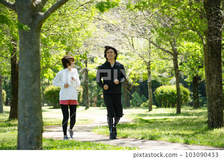 Young couple running in the park Young couple running in the park 103090433
