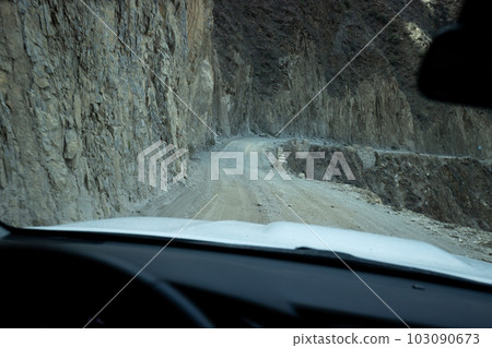 Driving car on the landslide mountain trail, China 103090673