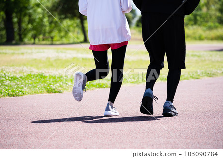 Feet of a couple running in the park Feet of a couple running in the park 103090784
