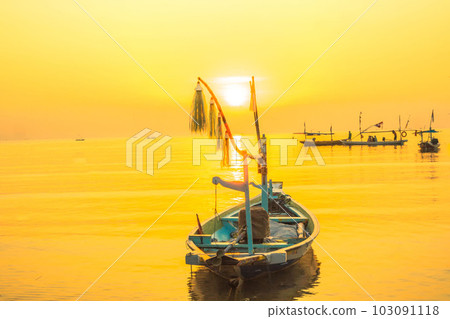 Moored boats during sunrise with yellow sky in Kenjeran, Surabaya, Indonesia. 103091118