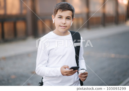 Teenage boy use wireless headphones for listening music 103093299