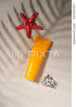 Summer sunscreen cream on sand background with shadow of palm leaf. Summer sunscreen cream on sand background with shadow of palm leaf. 103095567