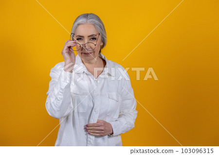 Positive and determined senior woman in light shirt Positive and determined senior woman in light shirt 103096315