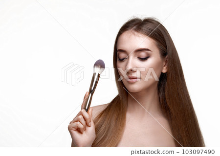 attractive woman with make-up brush for powder 103097490