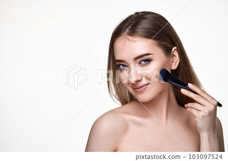 smiling lovely lady posing with make-up brush for powder 103097524