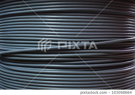Close-up of a cable bay. Coiled cable in a polymer winding in a storage warehouse of a manufacturing enterprise. Close-up of a cable bay. Coiled cable in a polymer winding in a storage warehouse of a manufacturing enterprise. 103098664