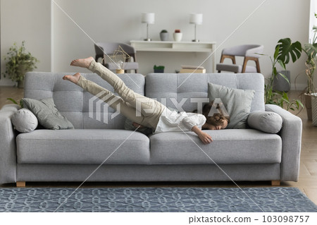Little girl flop down on sofa at home Little girl flop down on sofa at home 103098757