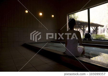 Back view of a young woman taking an indoor bath 103099357