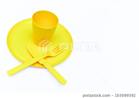 Plastic yellow knife, forks, cup, plate for camping, isolated on white Plastic yellow knife, forks, cup, plate for camping, isolated on white 103099392
