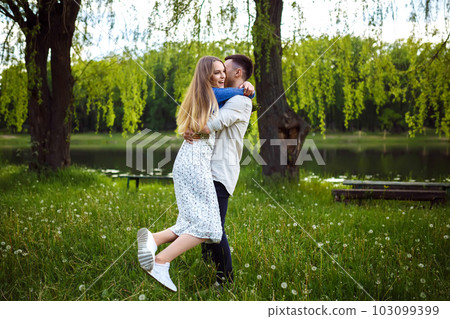 Couple in love enjoying tender moments during sunset . Couple in love enjoying tender moments during sunset . 103099399