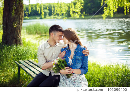 Couple in love enjoying tender moments during sunset . Couple in love enjoying tender moments during sunset . 103099400