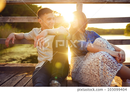 Couple in love enjoying tender moments during sunset . 103099404