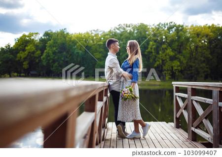 Couple in love enjoying tender moments during sunset . 103099407