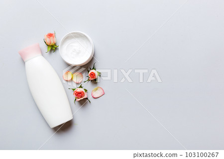 Fancy healthcare bottles for cream with rose flower. Natural oranic spa cosmetics concept. Mockup, template, Top view 103100267