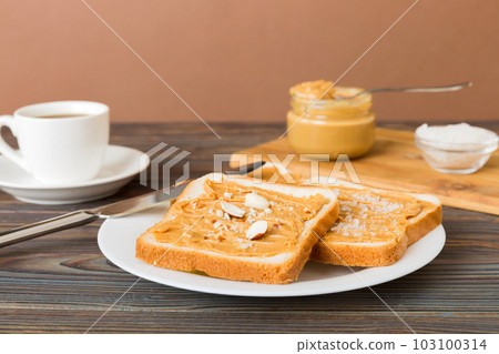 Peanut butter sandwiches or toasts on light table background.Breakfast. Vegetarian food. American cuisine top view vith copy space 103100314