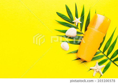 Sunscreen spray bottle. Bottle with sun protection cream and sea shells with tropical green leaf on color background, top view Sunscreen spray bottle. Bottle with sun protection cream and sea shells with tropical green leaf on color background, top view 103100378