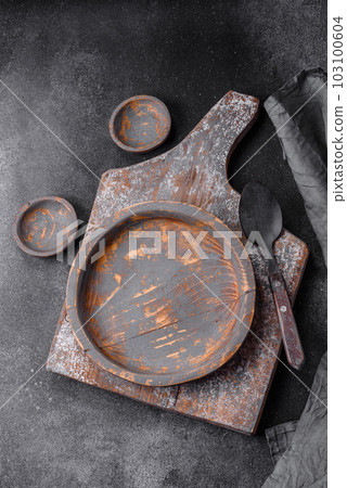 Empty wooden plate, knife, fork and cutting board Empty wooden plate, knife, fork and cutting board 103100604