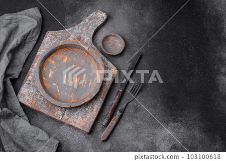 Empty wooden plate, knife, fork and cutting board Empty wooden plate, knife, fork and cutting board 103100618
