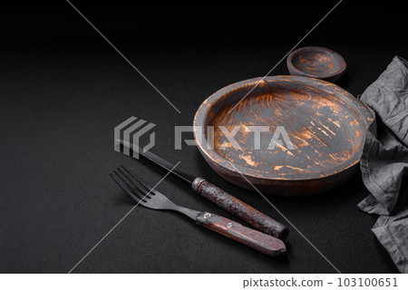 Empty wooden plate, knife, fork and cutting board Empty wooden plate, knife, fork and cutting board 103100651