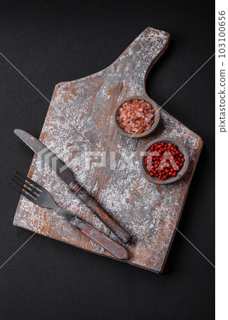 Knife, fork and cutting board, salt, pepper and other ingredients Knife, fork and cutting board, salt, pepper and other ingredients 103100656