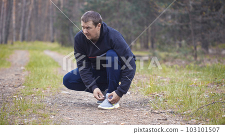Runner tying shoelaces on sneakers. 103101507