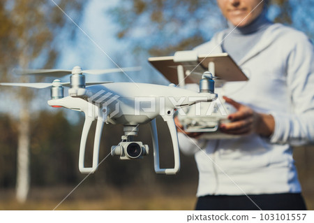 Flying the copter. Remote control in a women's hands 103101557