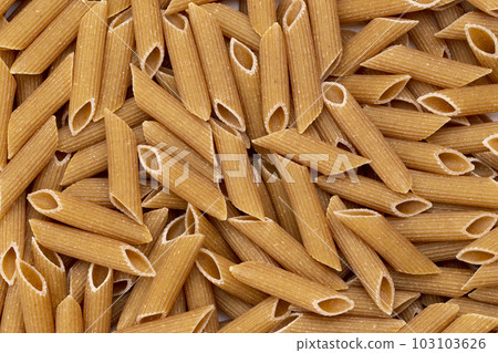Background from pasta. Penne, Penne Rigate. 103103626