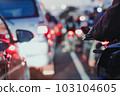 traffic jam from cars during rush hours on a city street in indonesia. A car on the highway in a traffic jam on the road. 103104605