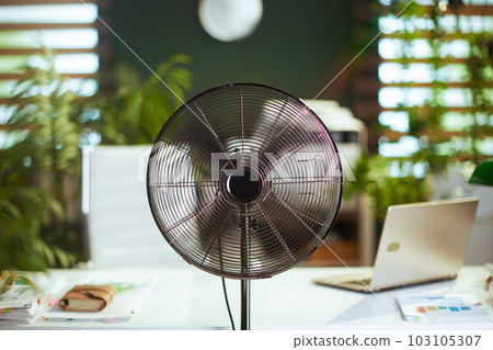 metal fan in modern green office 103105307