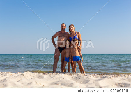 Family with twin sons having fun at the beach. Family with twin sons having fun at the beach. 103106156