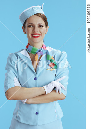 smiling elegant flight attendant woman on blue 103106216