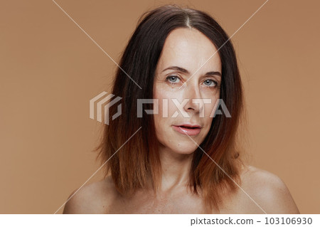 Portrait of 40 years old woman isolated on beige background Portrait of 40 years old woman isolated on beige background 103106930