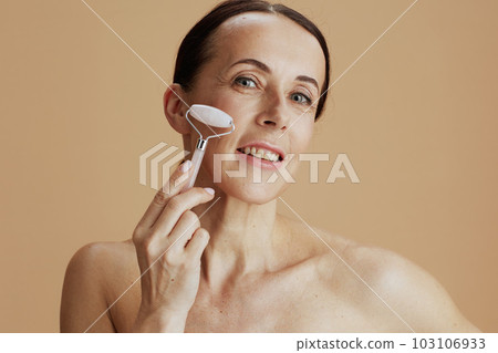 Portrait of happy modern woman on beige background 103106933