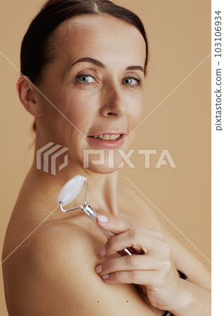 modern female with roller massager isolated on beige 103106934