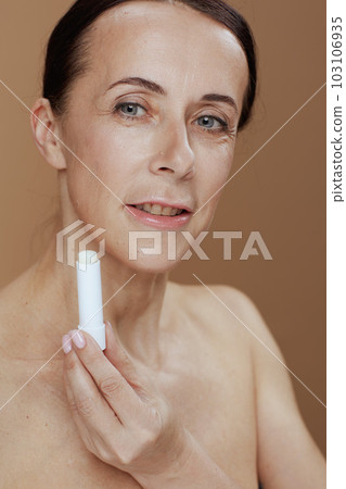 modern 40 years old woman isolated on beige background modern 40 years old woman isolated on beige background 103106935