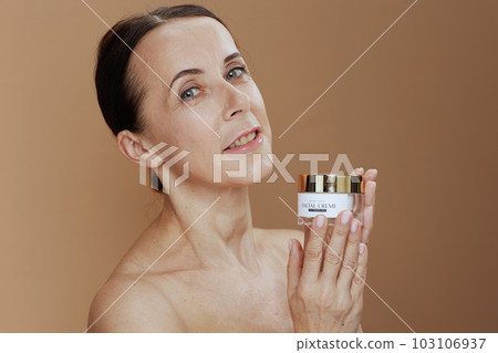 Portrait of modern 40 years old woman on beige background Portrait of modern 40 years old woman on beige background 103106937