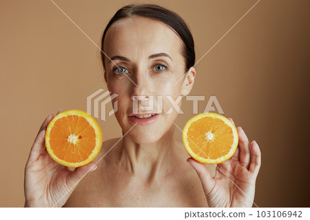 modern woman with orange on beige background 103106942