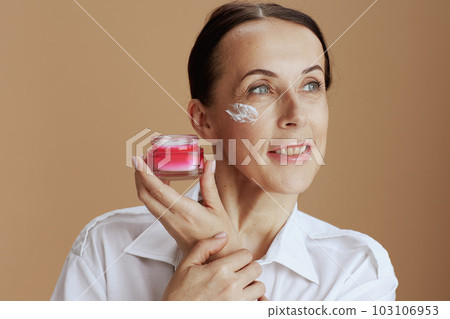 smiling modern woman in white shirt on beige background 103106953