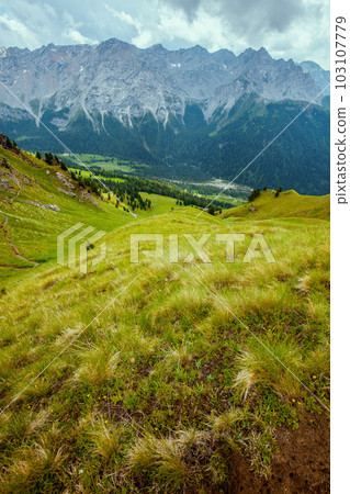 landscape with mountains, hills, clouds, grass and trees landscape with mountains, hills, clouds, grass and trees 103107779