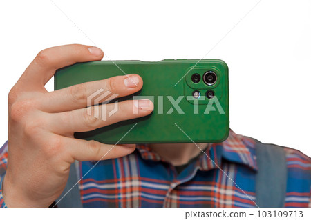 Hand of a man in shirt close-up holding a mobile phone or smartphone in a green case on a white background, isolated 103109713