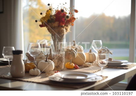 Seasonal table setting with pumpkins and flowers Seasonal table setting with pumpkins and flowers 103110197