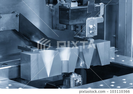 Closeup scene the wire EDM machine cutting the mold insert parts. Closeup scene the wire EDM machine cutting the mold insert parts. 103110366