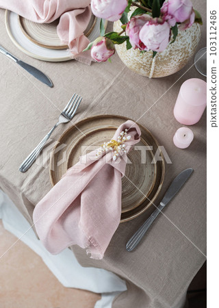 table with linen tablecloth in beige color 103112486
