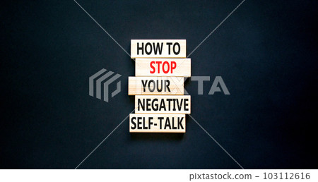 Stop negative self-talk symbol. Concept words How to stop your negative self-talk on wooden block. Beautiful black table black background. Psychological negative self-talk concept. Copy space 103112616