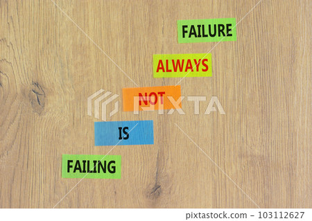 Failure or failing symbol. Concept words Failing is not always failure on colored paper. Beautiful wooden table wooden background. Business, failure or failing concept. Copy space. Failure or failing symbol. Concept words Failing is not always failure on colored paper. Beautiful wooden table wooden background. Business, failure or failing concept. Copy space. 103112627