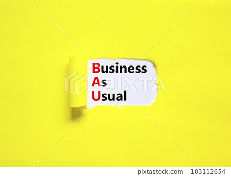 BAU business as usual symbol. Concept words BAU business as usual on white paper on a beautiful yellow background. Business and BAU business as usual concept. Copy space. 103112654